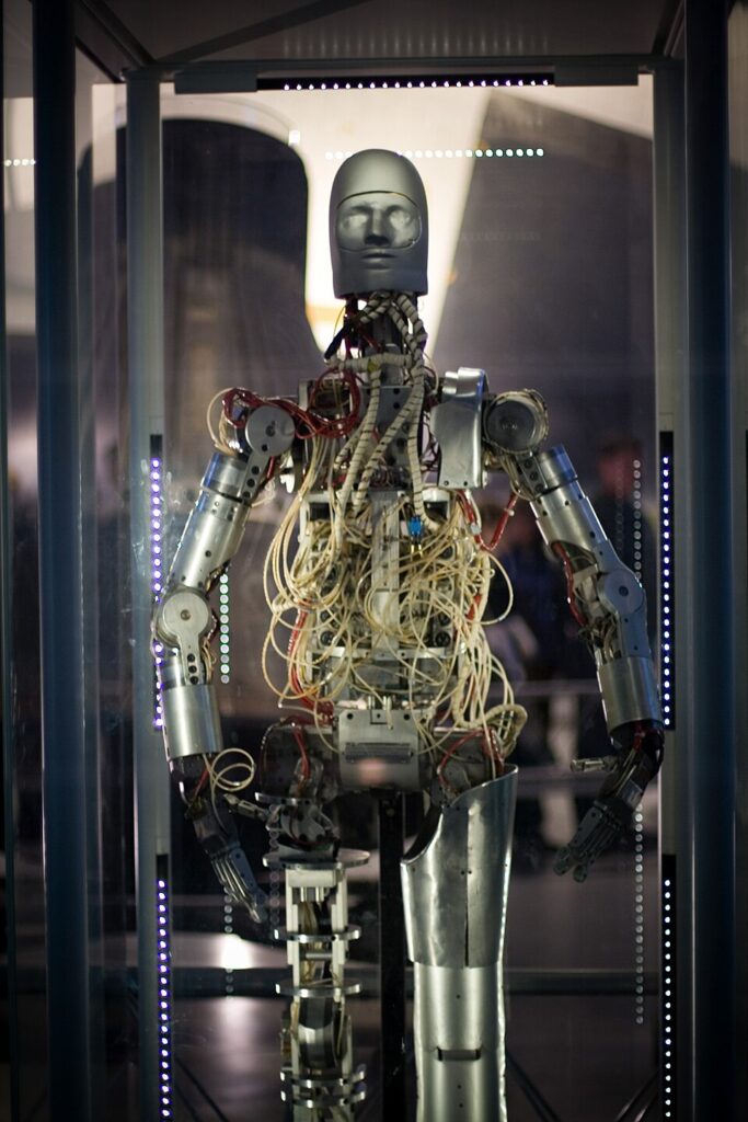 Photo of a humanoid robot with an open torso full of tubes and cables