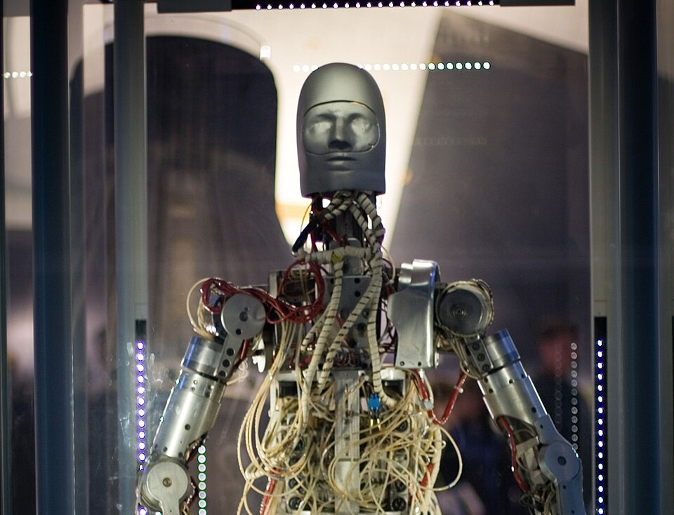 Photo of a humanoid robot with an open torso full of tubes and cables